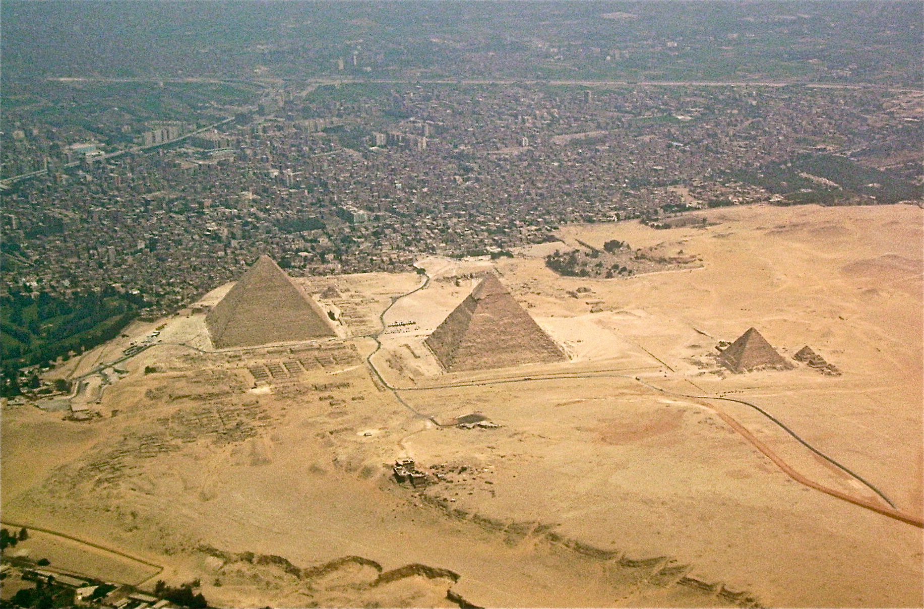Aerial photograph of the Giza pyramid complex and surrounding city.